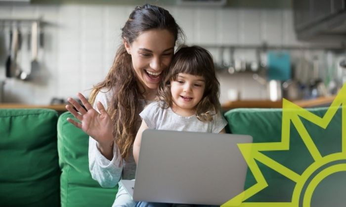 Frau mit Kind vor einem Laptop bei einem Videochat