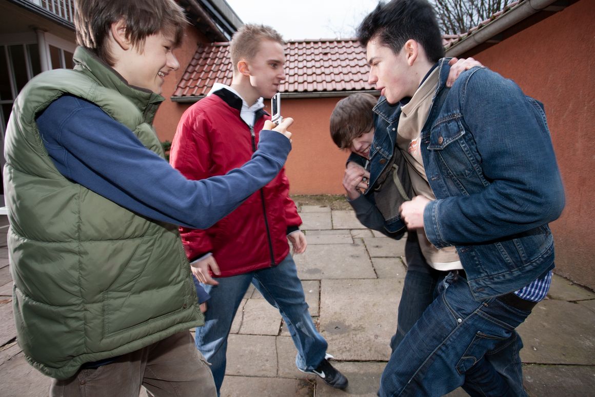 Gewalt unter Schülern. Drei Jungen verprügeln einen Mitschüler.